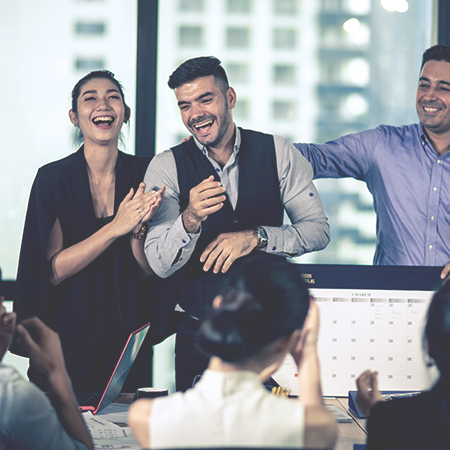Successful entreprenours and business people laughing in an office